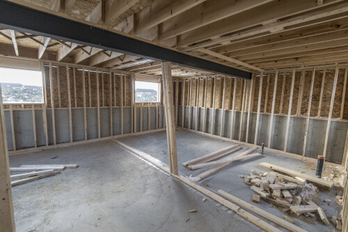 An empty basement is bare down to the studs. This is an open area ready for renovations. 