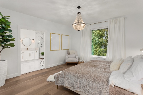A remodeled master suite bedroom has a modern and open style.