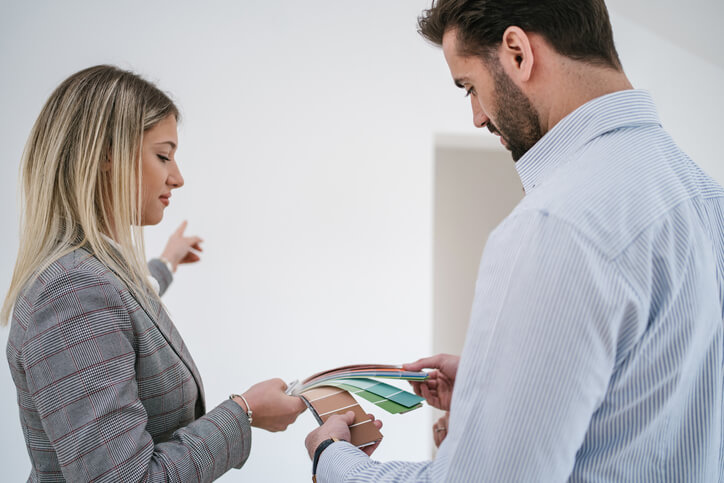 A couple looks through a color scheme for their home remodeling project.