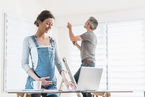 A couple does some work on their house to prepare for their baby that is on the way.